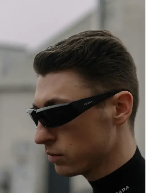 man wearing sleek black Luxury Eyewear, showcasing bold, modern design with the logo visible